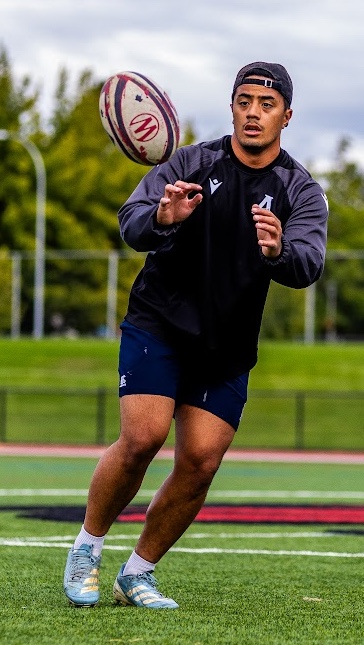 A CWU rugby player prepares to catch a ball at a recent practice.