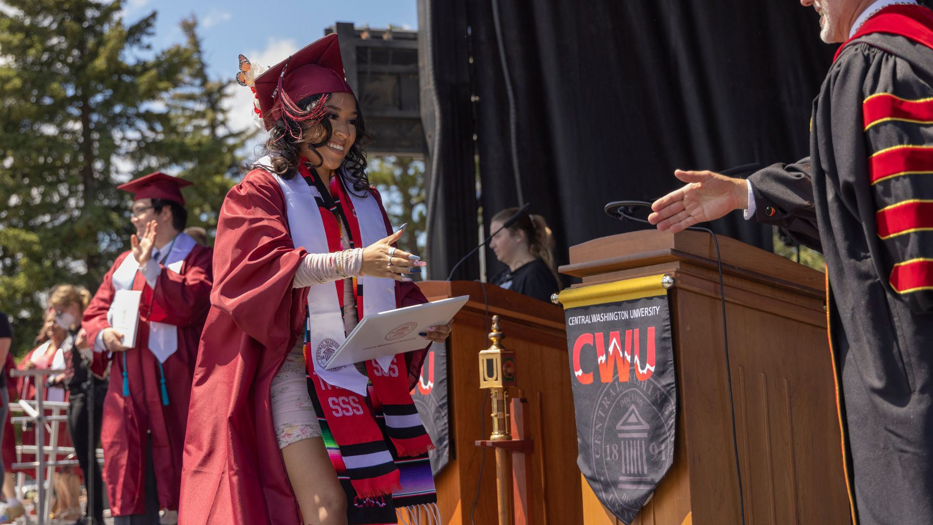 Michelle Reyes, walks across the stage to accept her diploma