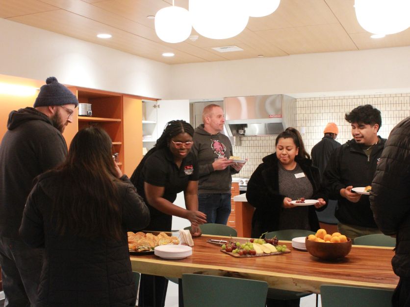 The Multicultural Center's Kitchen area, full of people eating sandwiches.