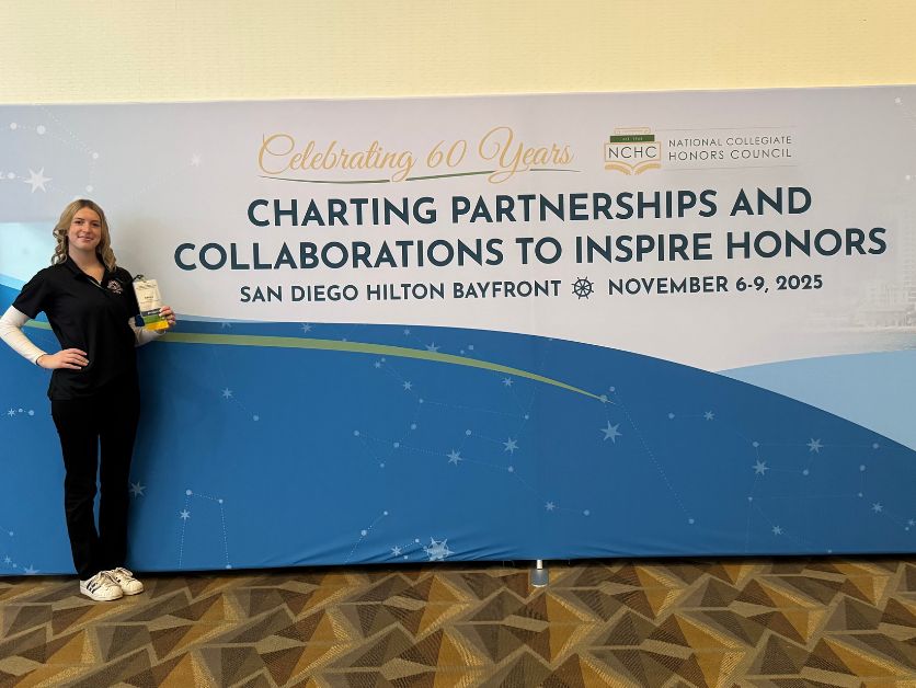 Photo of Brittany Case with a banner that reads Charting Partnerships and Collaborations To Inspire Honors