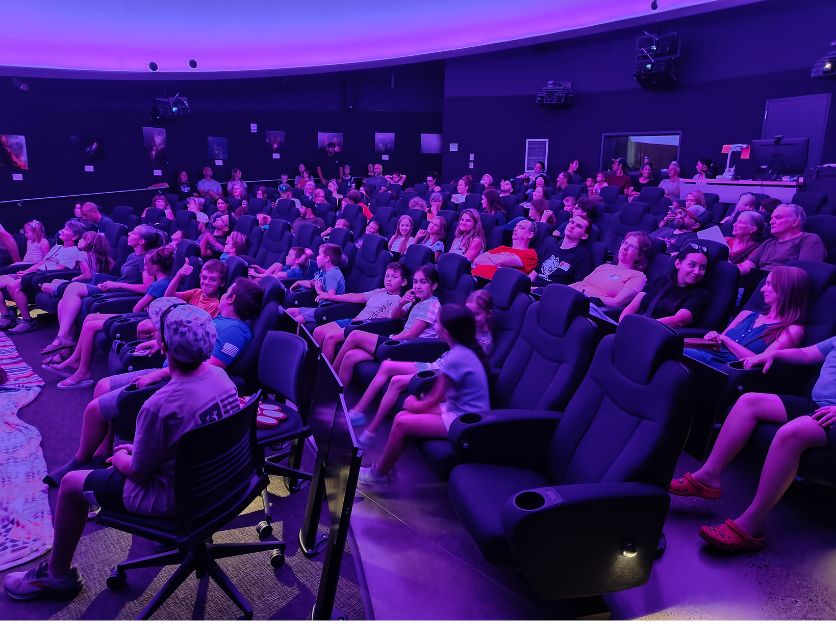 A crowd is assembled in the planetarium