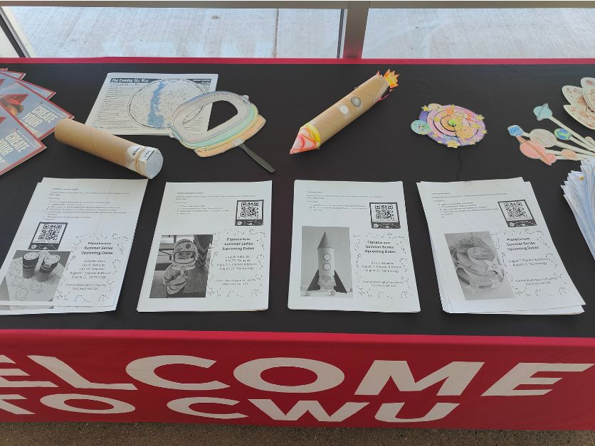 Take-home crafts are assembled on a table.