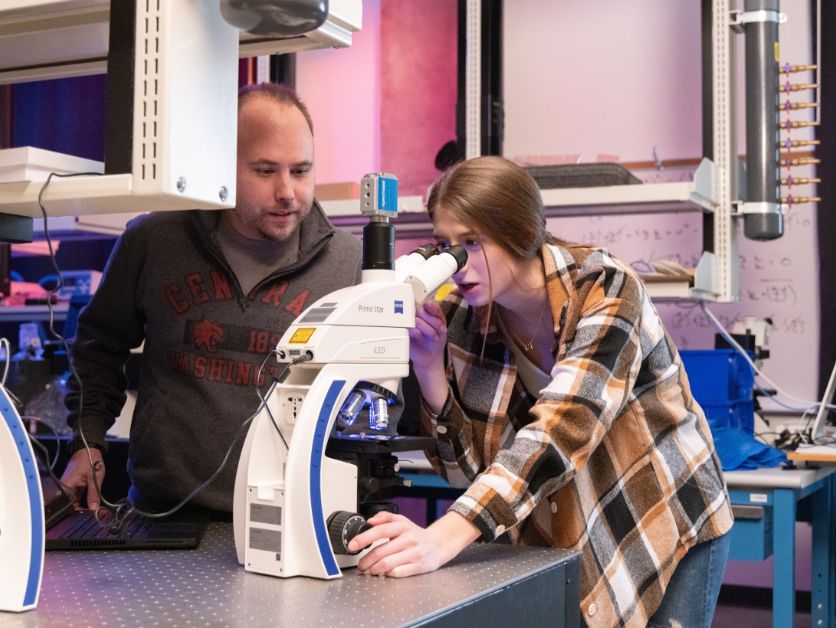 A CWU student looks in astonishment at how well a donor-funded microscope shows her small things.