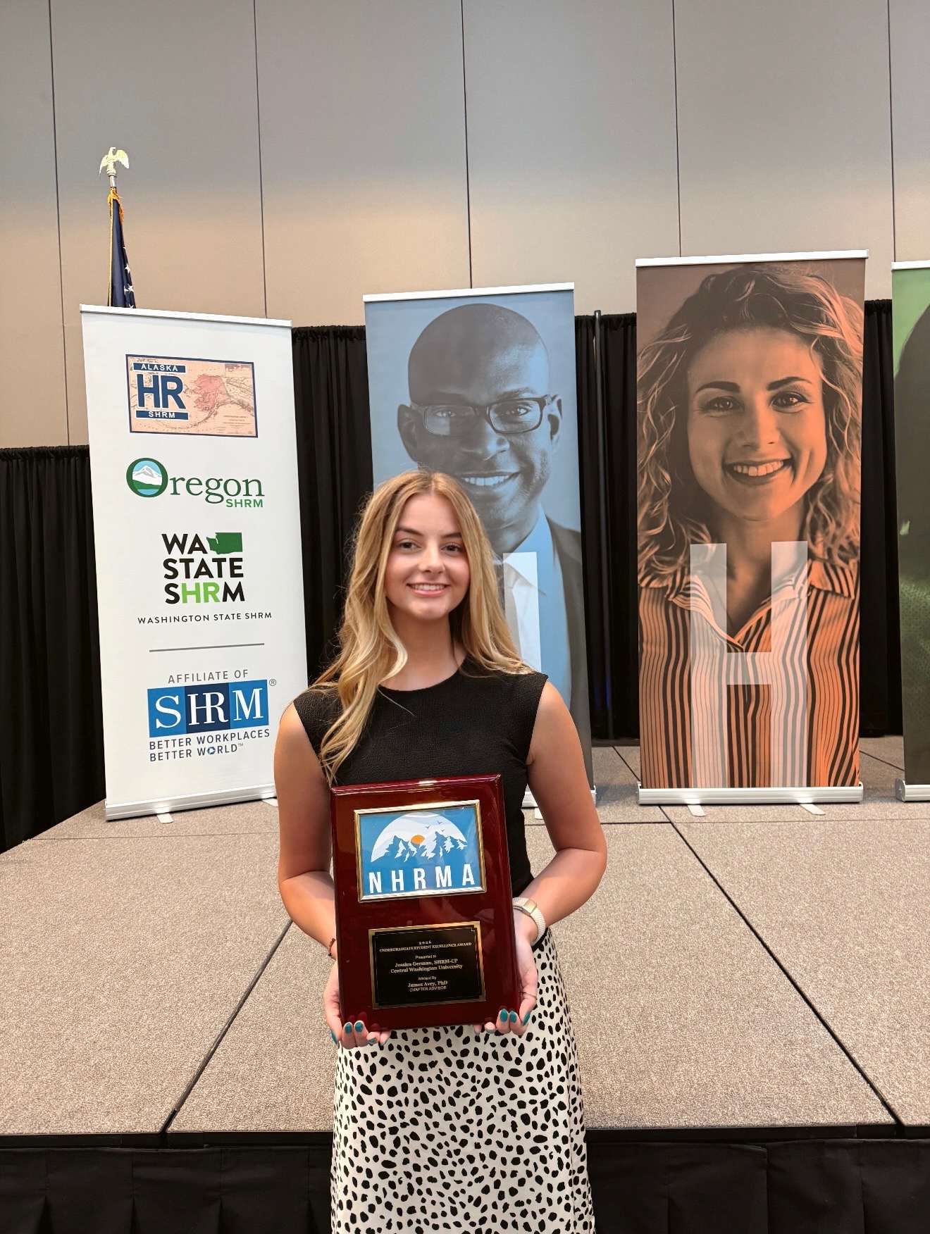 Jessica German holds up her award.