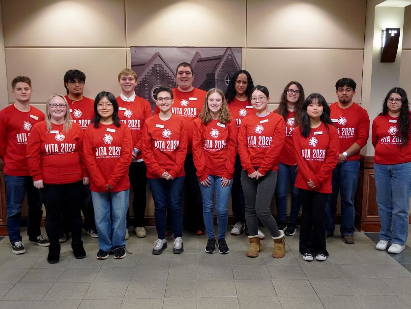 Photo of half of this year's VITA volunteers in their uniforms