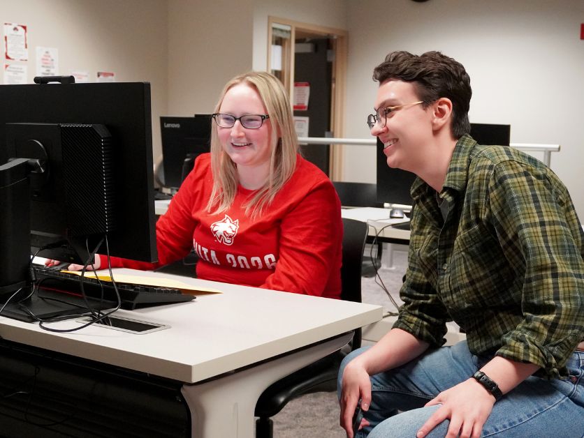 Photo of a VITA volunteer engaging with Center for Financial Planning and Well-being administrator Luke Love.