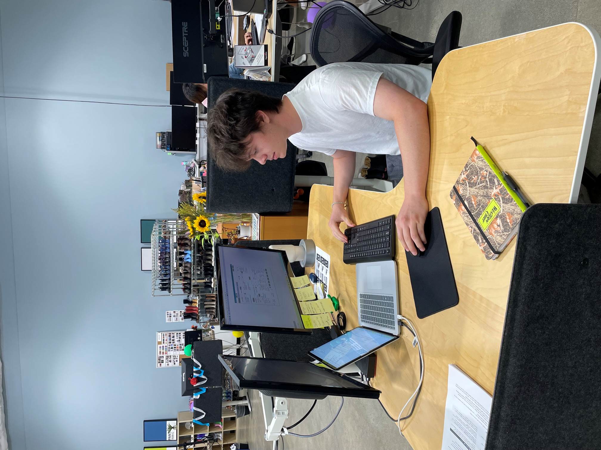 Samuel Lombardi doing work at a very busy-looking computer.