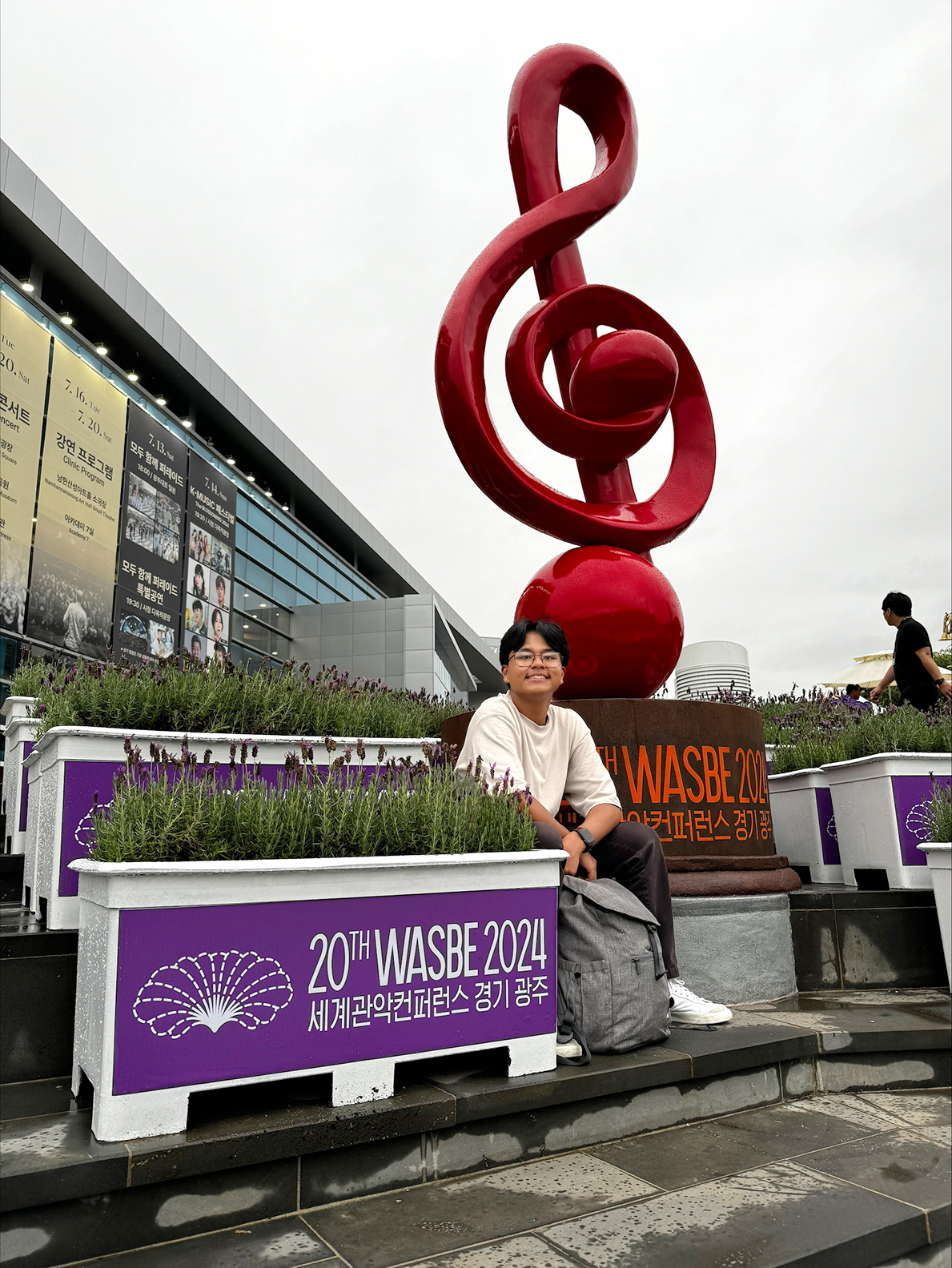 Josh Dequiroz in front of a WASBE sign