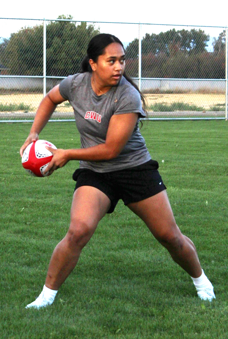 A CWU women's rugby club player prepares to pass the ball.