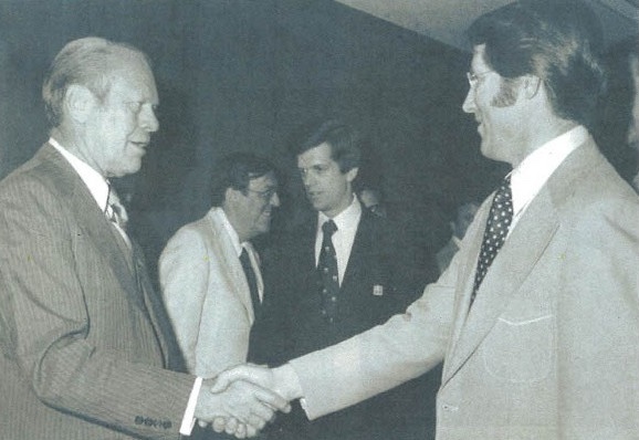 CWU alumnus Dale Comstock, right, shakes hands with former President Gerald Ford