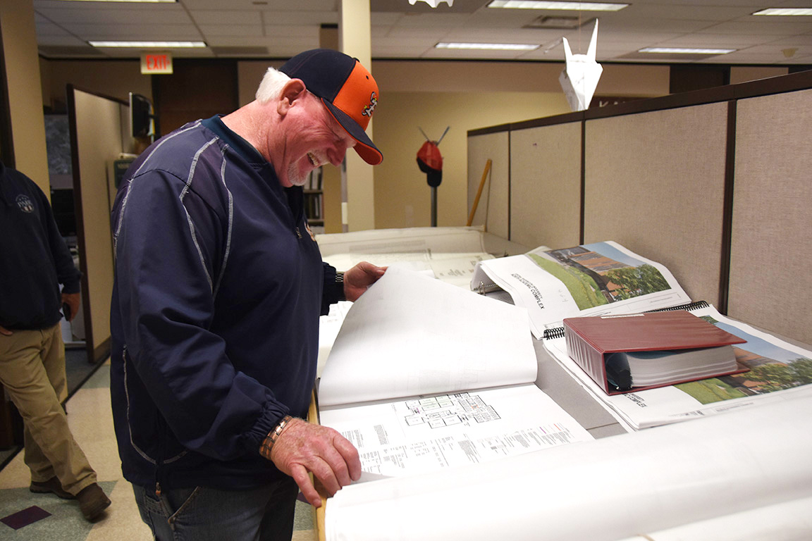 Dave Kopczynski looks at building plans inside Jongwaard Hall