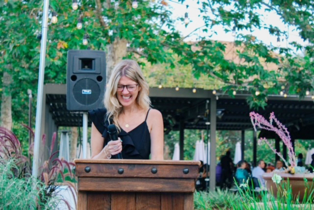 Massar speaking at a podium