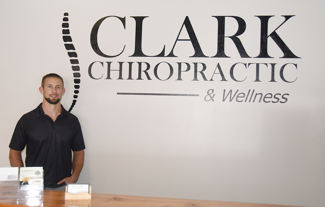 Dillon Clark at the front desk of his chiropractic center.