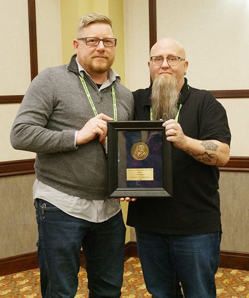 Jerry Dougherty receives the Gold Medallion Award at the KCACTF Region 7 conference.