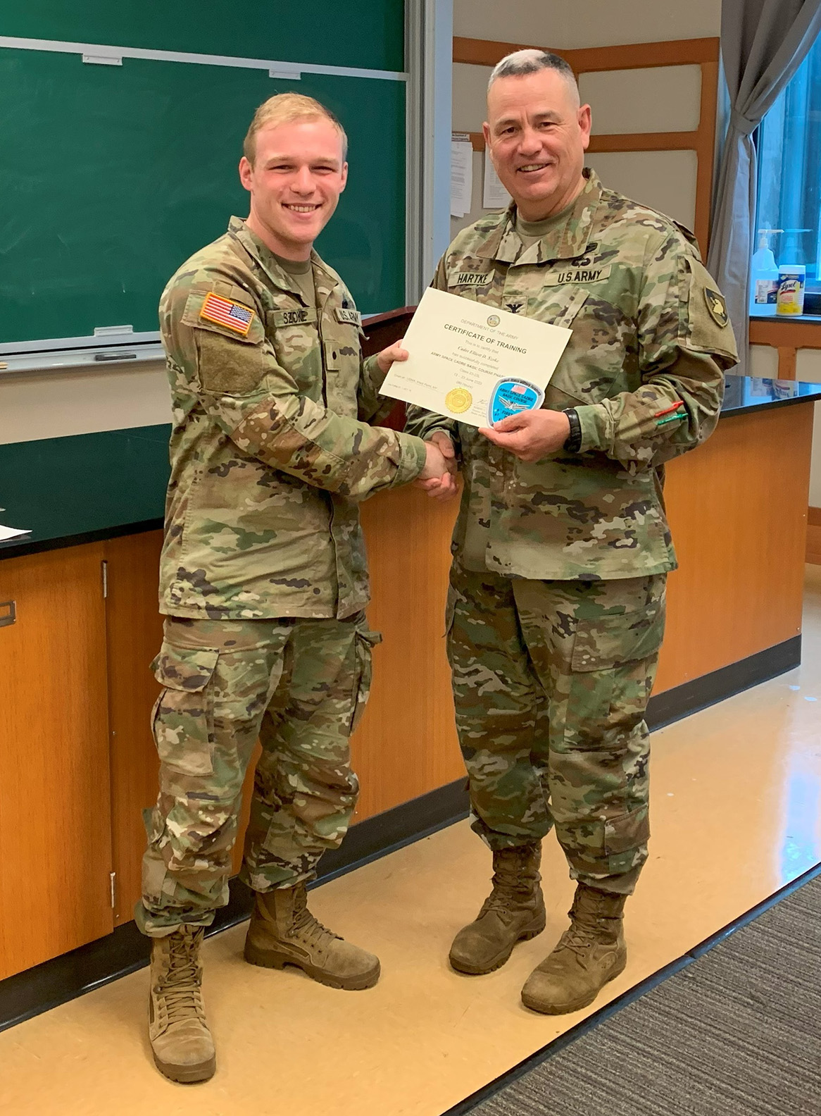 Elliott Szoke shakes hands with National Guard instructor