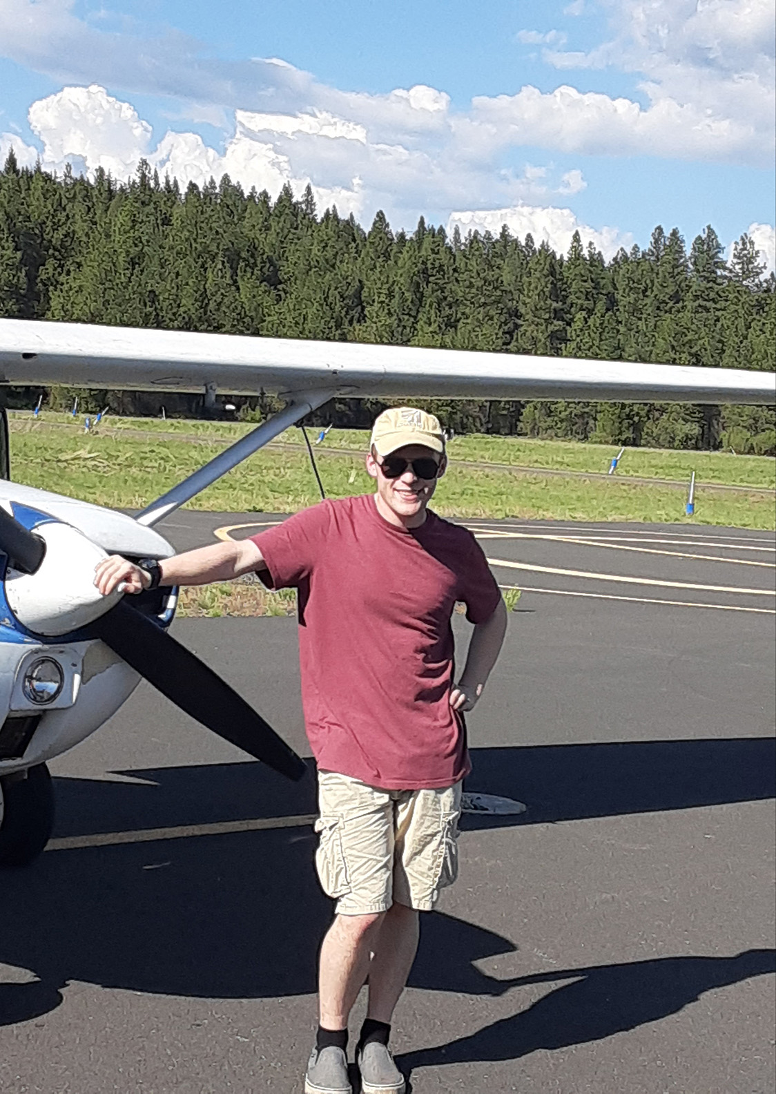 Elliott Szoke next to a small aircraft
