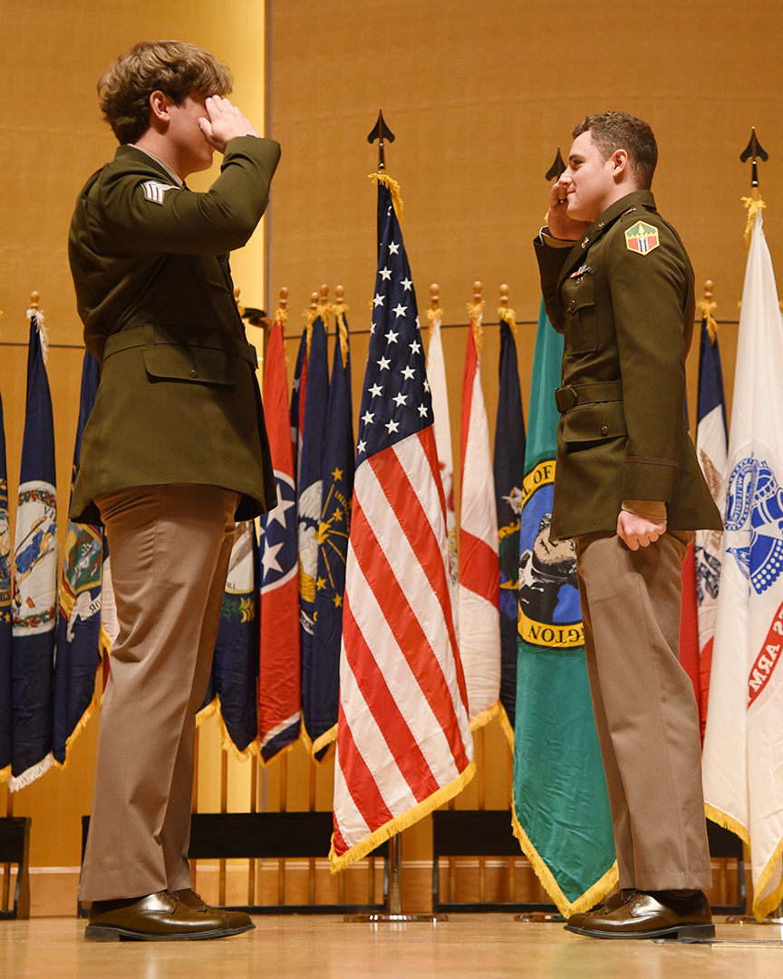 Ethan McKune, right, salutes one of his ROTC classmates
