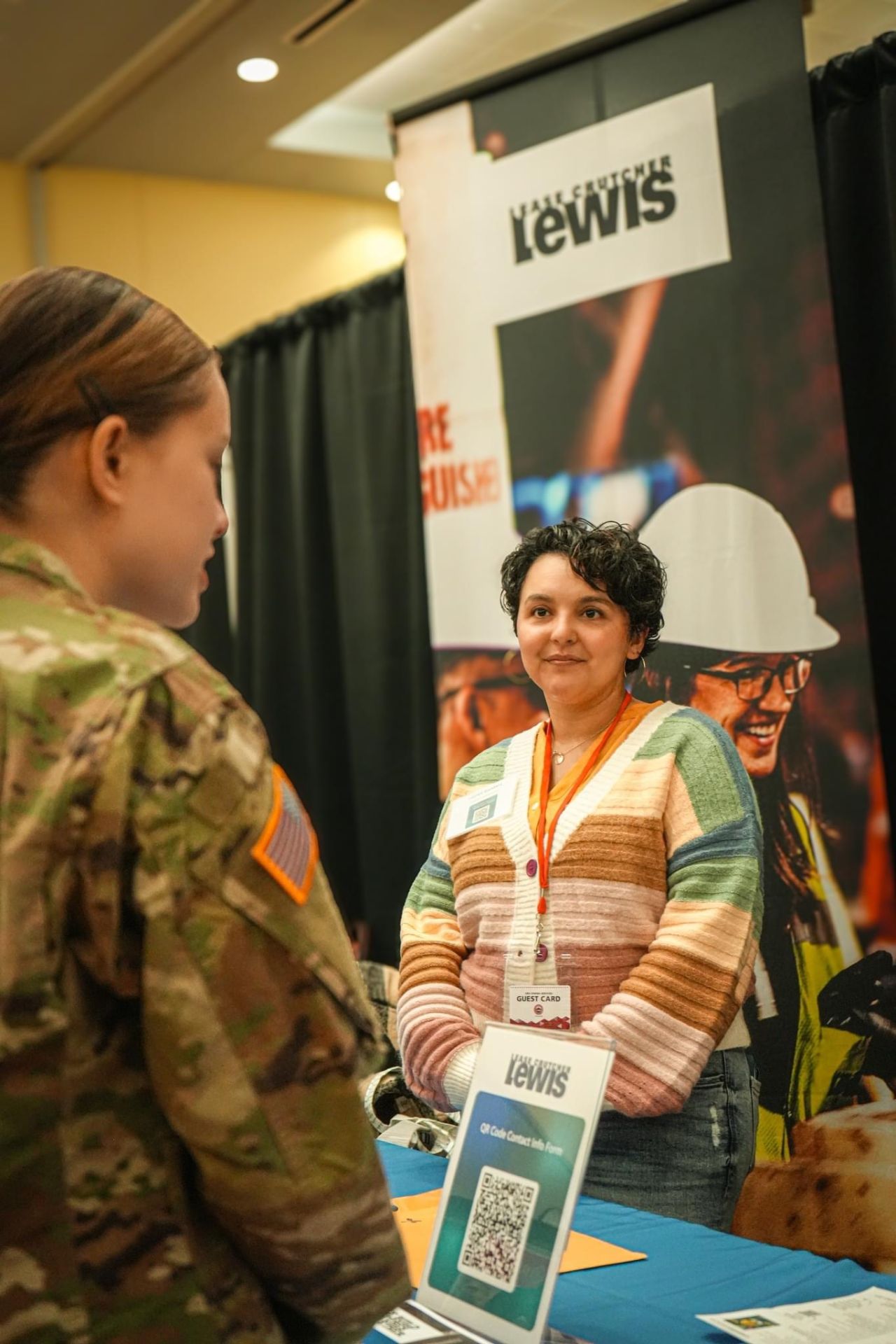 An employer talks to a CWU student at the career fair