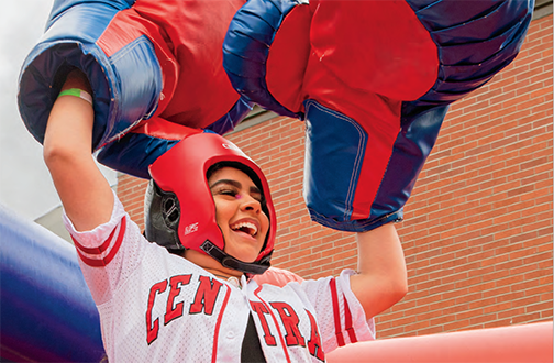 First-generation CWU student Sandra Rojas celebrates a boxing victory at the 2022 Wildfest end-of-year celebration on the CWU campus.