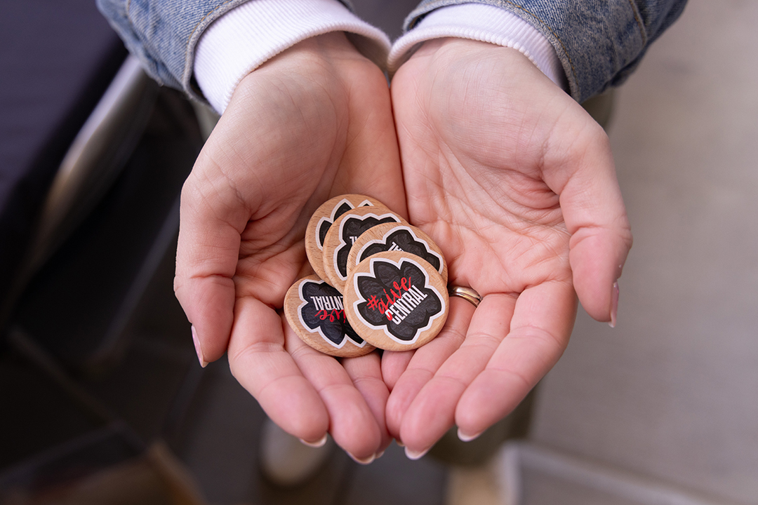 Two hands filled with #GiveCentral tokens