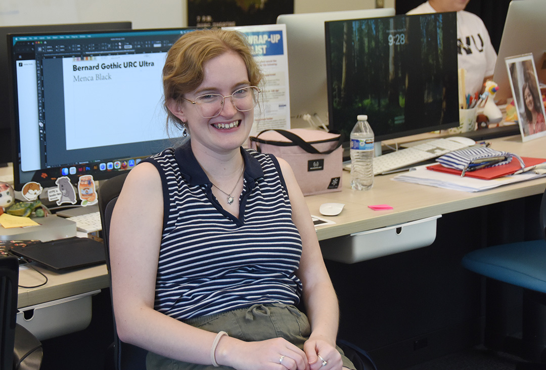 Laura Allen shares a laugh with a colleague in the Publicity Center