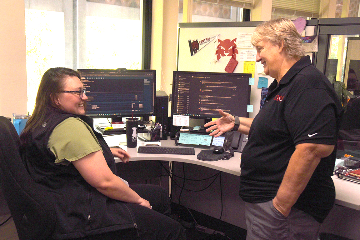 JoAnn Page talks to a colleague in the CWU Admissions office