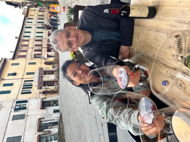 Joe and Lieu Ritchie share a glass of wine on a patio