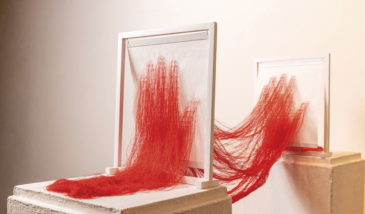 A red thread sculpture by CWU professor Kate Im