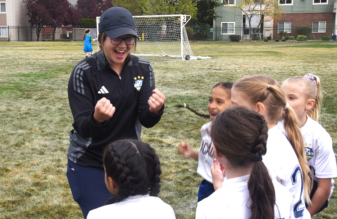 Kayla Gout leads her youth soccer players in a cheer