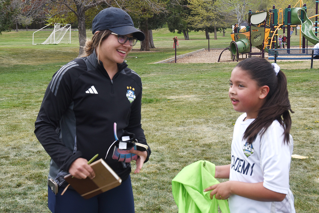 Kayla Gout talks to one of her youth soccer players