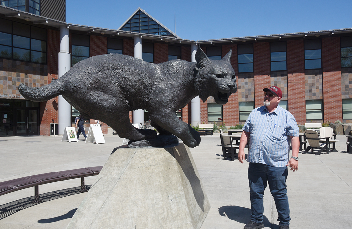 Keith Jones admires the Wildcat statue outside of the SURC
