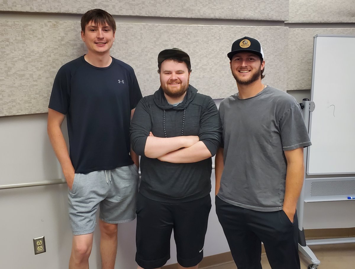 Three CWU Business students who put on a classic car show
