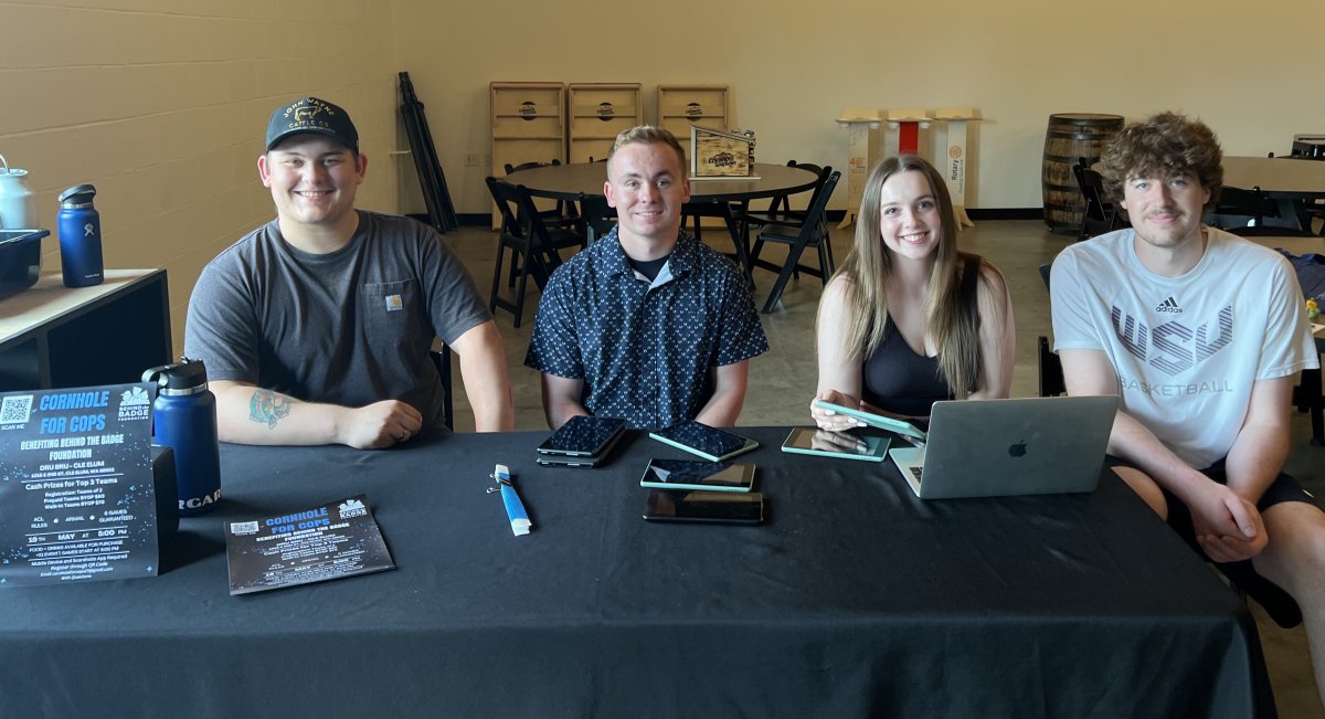 Four CWU Business students who put on a Cornhole for Cops event this spring
