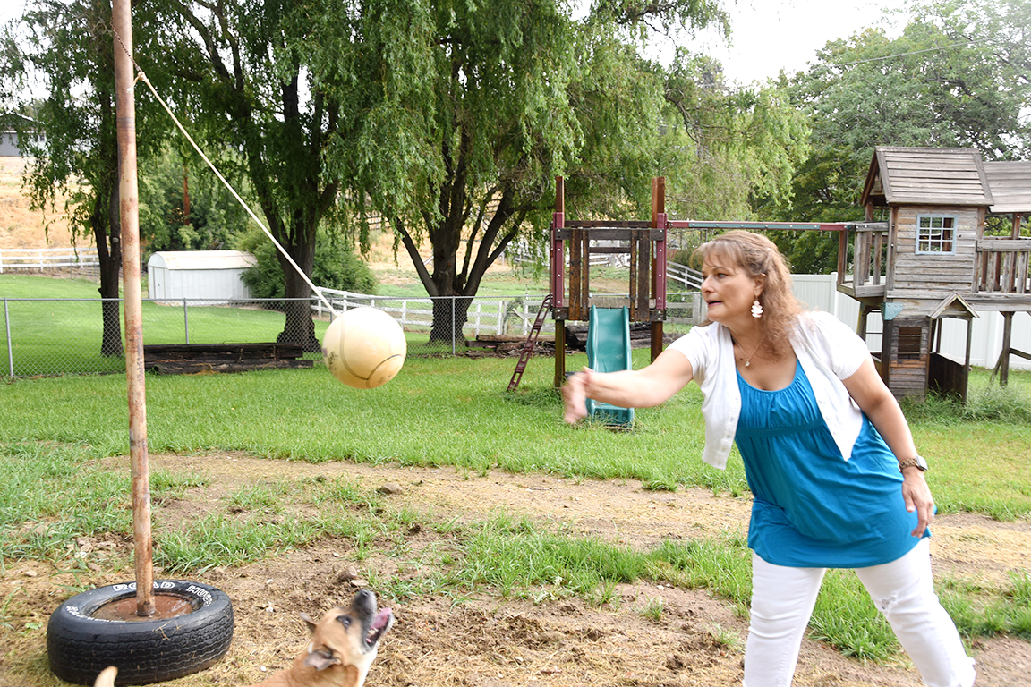 Lidia Anderson plays with her dog at her home in Selah