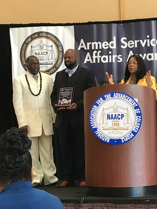 Richard Matthews receives an award from the NAACP