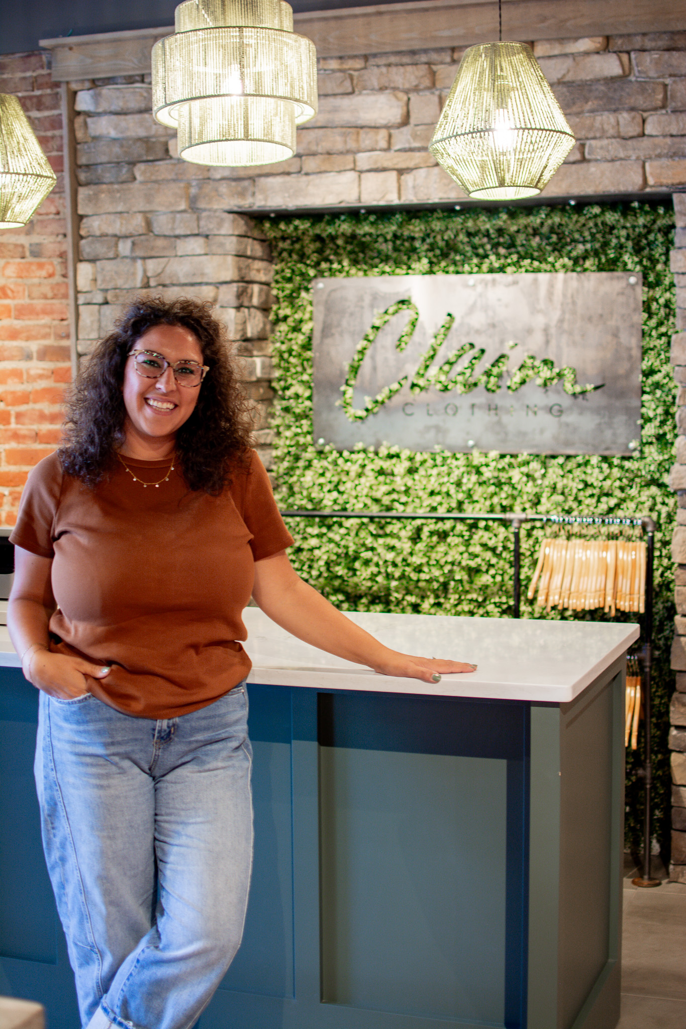 Megan West stands in front of the Claim Clothing sign at her business.