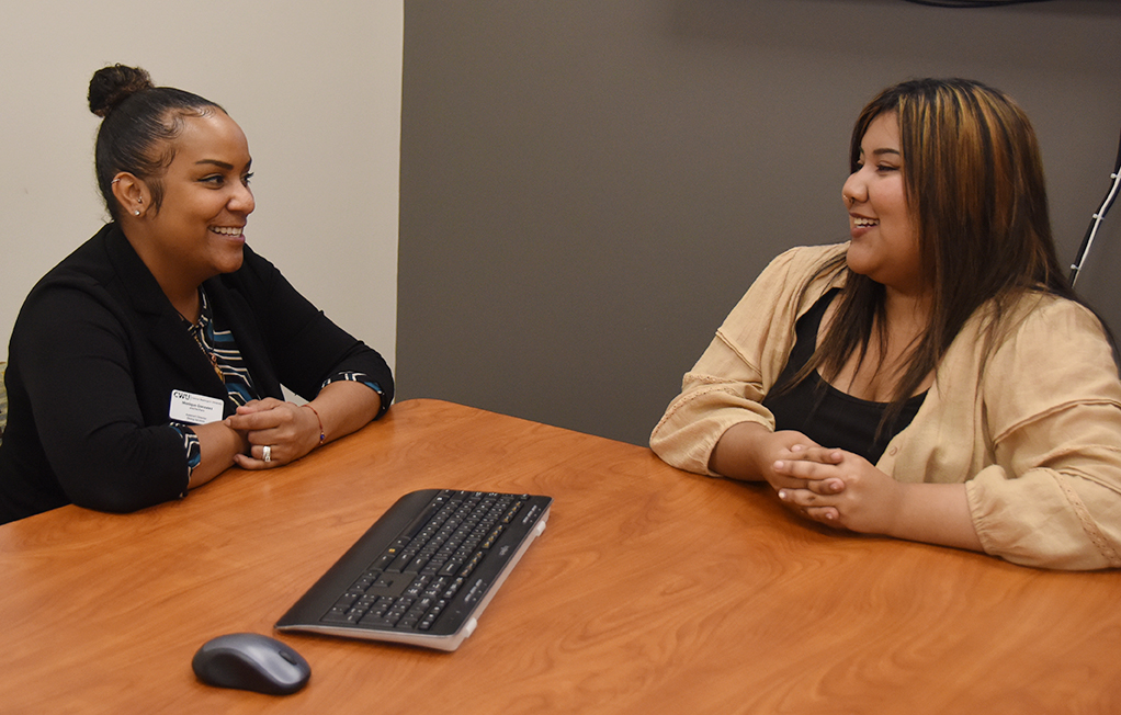 Gonzales meets with Student Hiring Manager Adriana Garza in the Dining Services office.