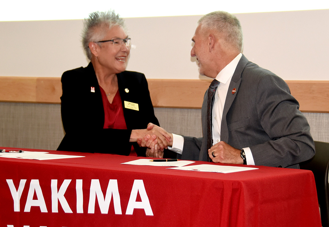 YVC President Teresa Rich and CWU President Jim Wohlpart celebrate their MOU signing on May 26