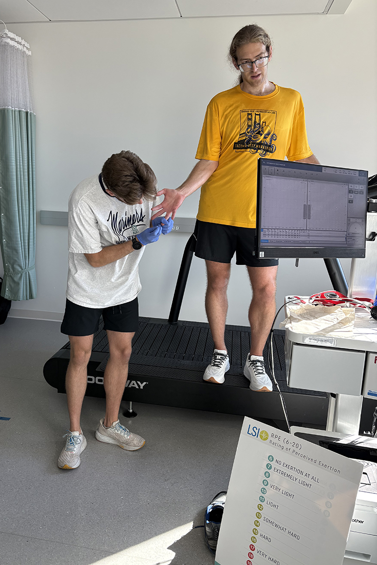 Herde collects data with his brother, who was a participant in the running resiliency research study