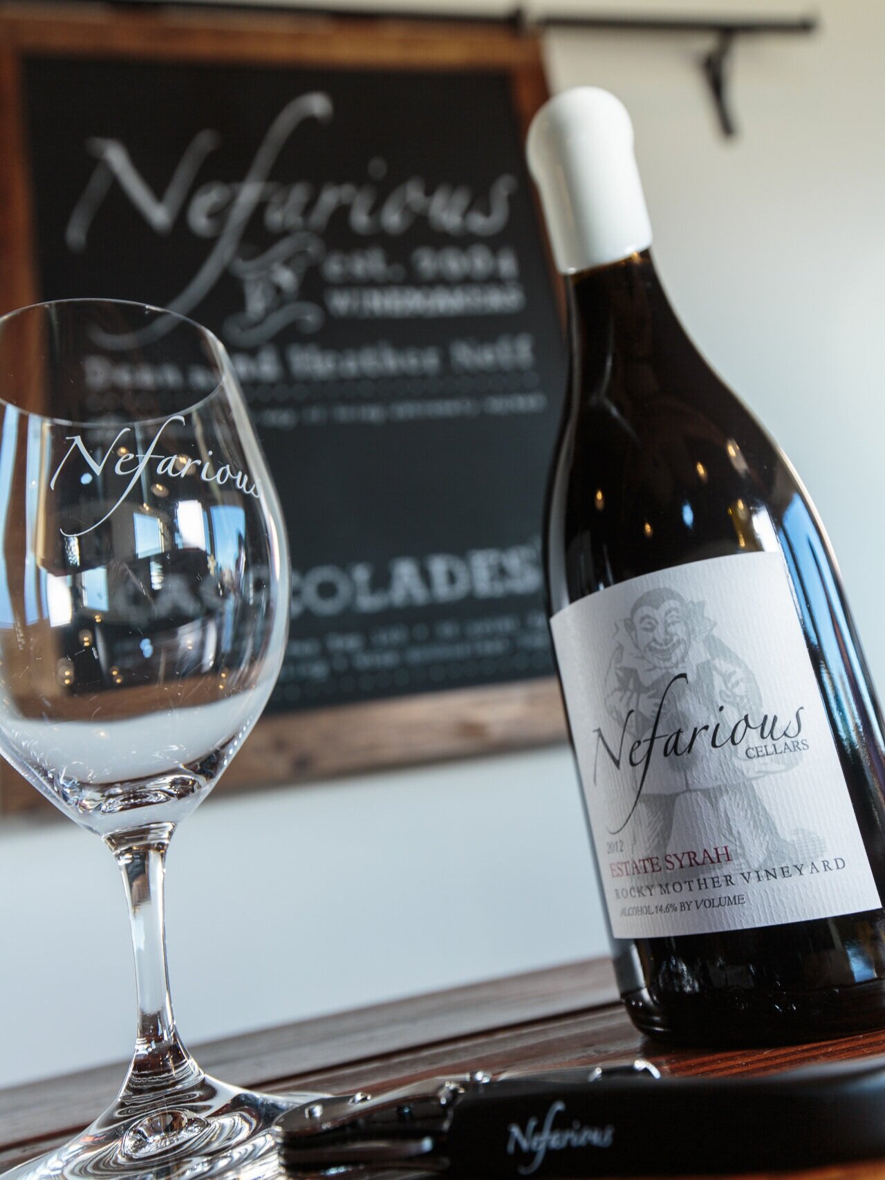 Bottle of Nefarious Cellars wine next to a glass