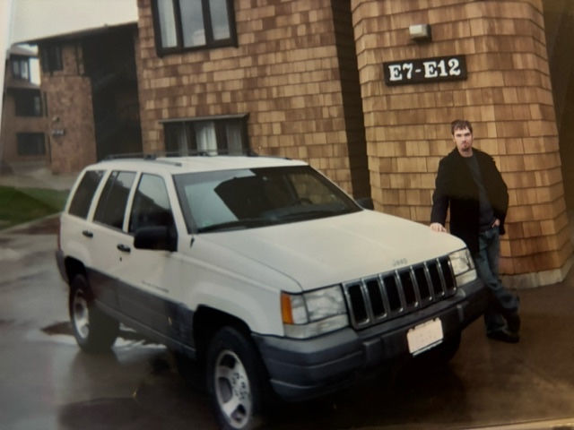 Neil Hewiston outside Kamola Hall with his Jeep