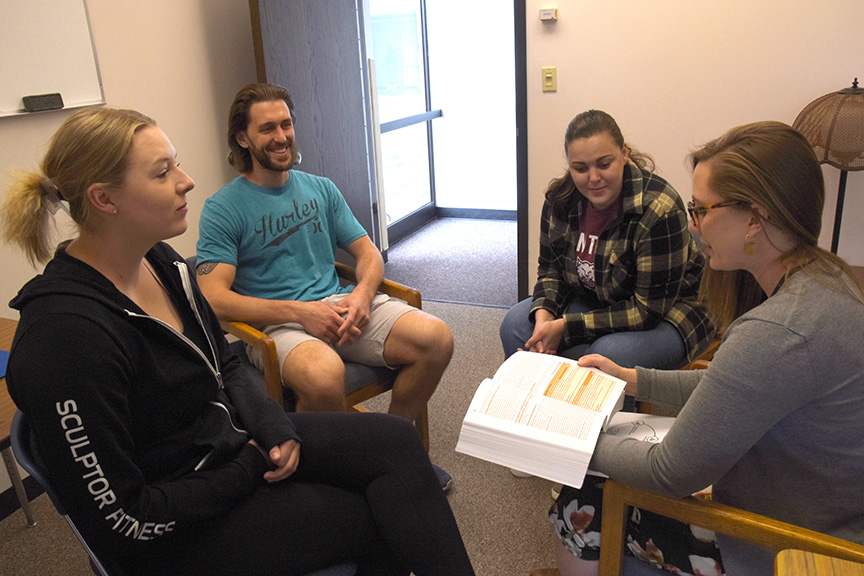 Assistant Professor Olivia Holter, right, meets with School Psychology graduate students Courtney Deveny, left, Mason Berndt, and Kali Davis in the CWU Psychology Building.