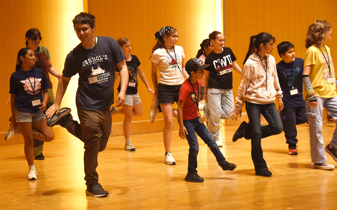 Campers and instructors practice a line dance in the Hertz Concert Hall at CWU.
