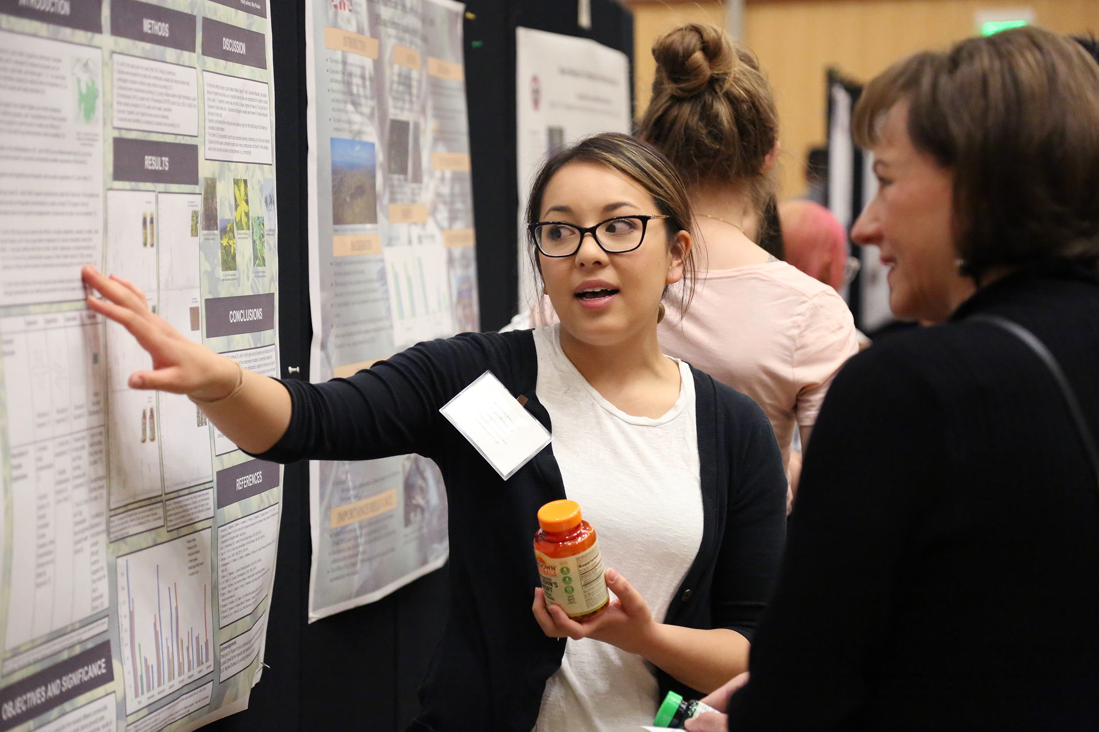 A CWU student presents a poster at a past SOURCE conference