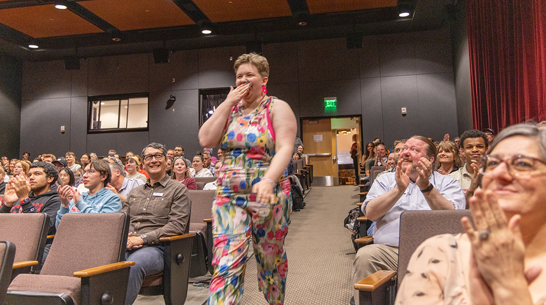 Student Employee Award recipient Rowena Wombold walks to the stage.
