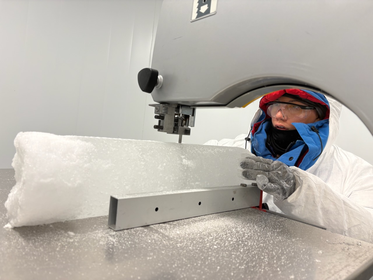 CWU student Tess Kraics cuts an ice core sample in the lab in Norway.