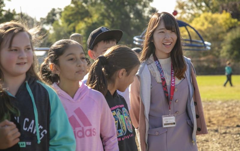 TGU student Riko Motokane with kids during recess at Lincoln Elementary School. 