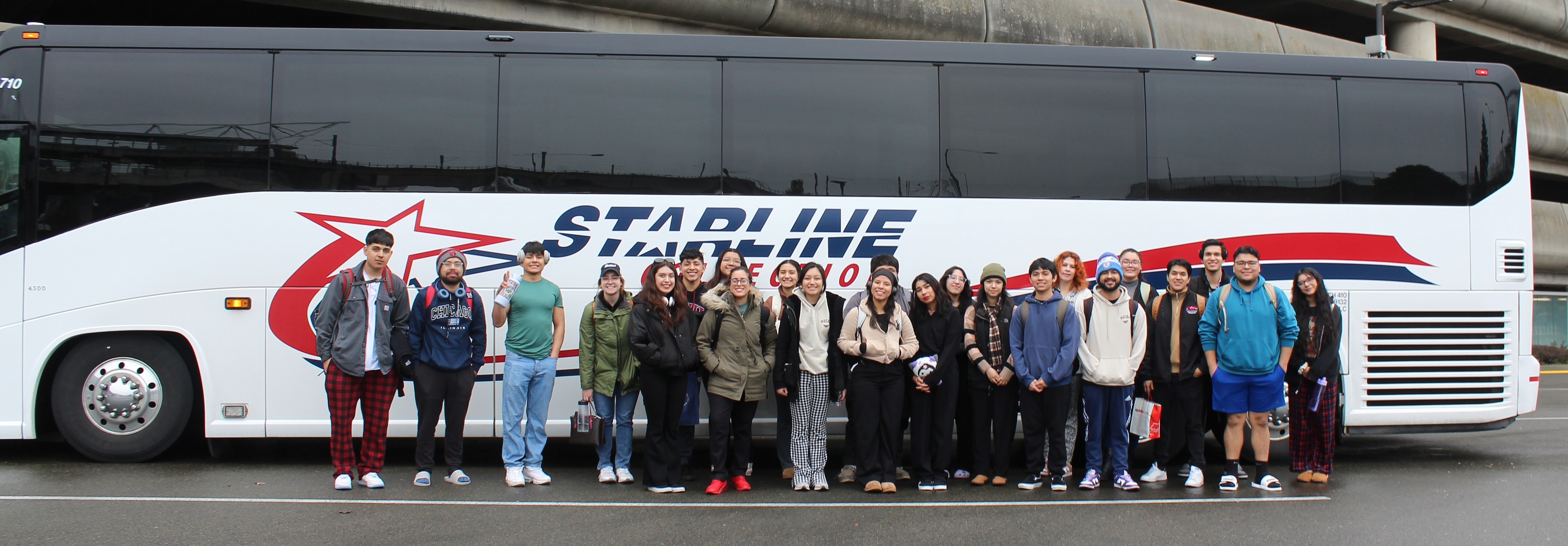 Group photo of USHLI participants in front of a tour bus