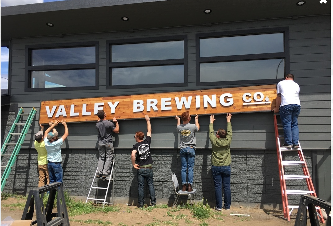 A group puts up the Valley Brewing sign in 2017