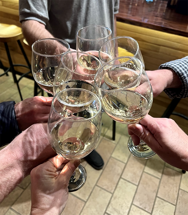 A toast with five wine glasses